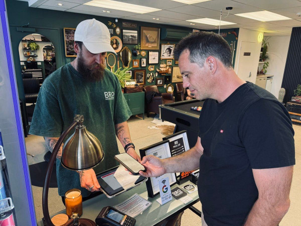 Southland MP Joe Mooney paying for a haircut in Queenstown with Bitcoin